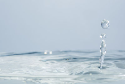 Close-up of water splashing against white background