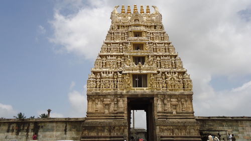 Low angle view of temple against cloudy sky