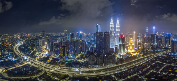 High angle view of illuminated buildings in city at night