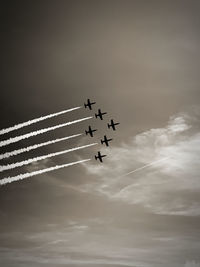 Low angle view of airshow in sky