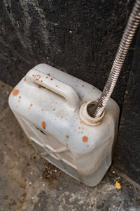 High angle view of abandoned container on wall