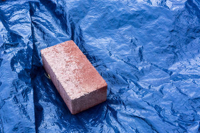 High angle view of brick on tarpaulin