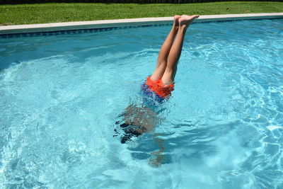 Woman diving into swimming pool