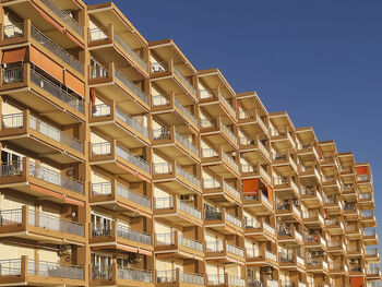 Low angle view of building against clear blue sky