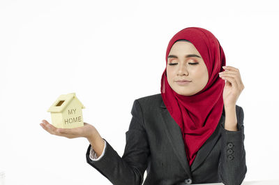 Portrait of a beautiful young woman against white background