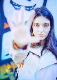 Portrait of beautiful woman showing stop gesture