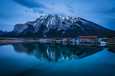 The dying light of day casts a reflection of mt. inglismaldie on the waters of lake minnewanka.