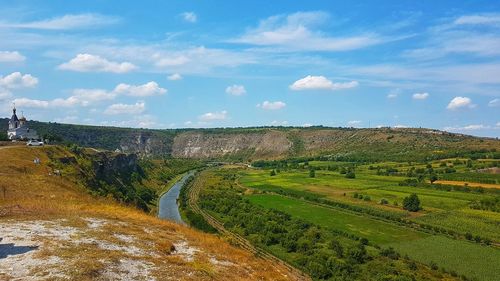 Scenic view of agricultural field against sky, raut river