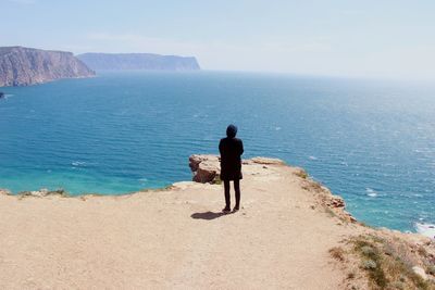 Rear view of woman walking on beach