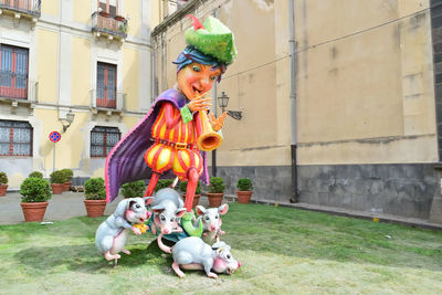 Woman with sculpture in yard