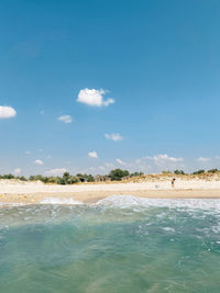 Scenic view of beach against blue sky