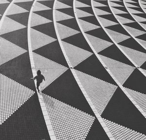 High angle view of man walking on tiled floor