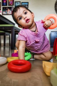 Boy playing with baby sitting on floor