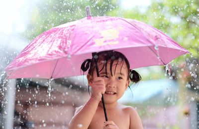 Cute girl with umbrella during rainy season