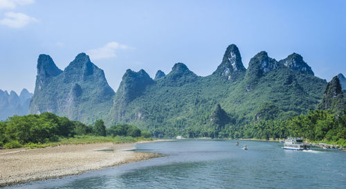 Scenic view of land and mountains against sky