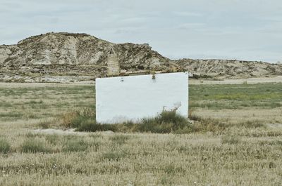 Built structure on field against sky