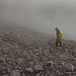 Man standing on landscape against sky