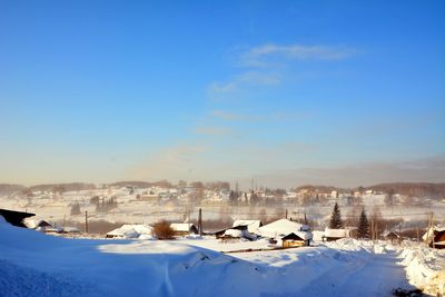 Snow covered field against sky