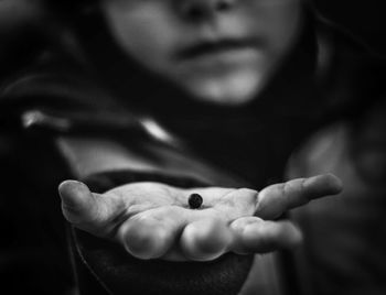 Close-up of boy hand holding seed