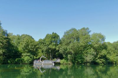 Scenic view of calm lake against clear sky