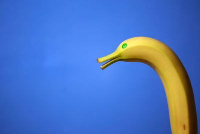 Close-up of banana against blue background