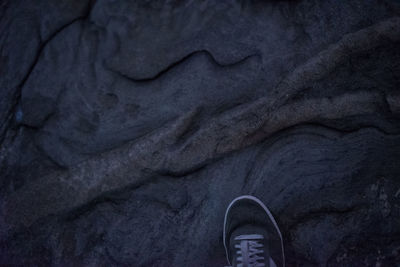 Low section of person standing on tiled floor