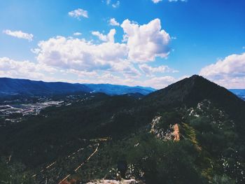 Scenic view of mountains against cloudy sky