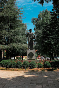 Statue in park against sky