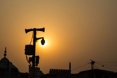 Low angle view of silhouette built structure against sky during sunset