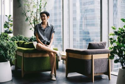 Woman sitting on sofa in building