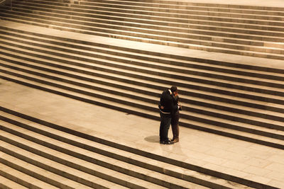 Couple kissing while standing on steps