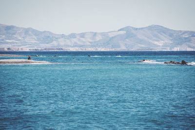 Scenic view of lake with mountains in background