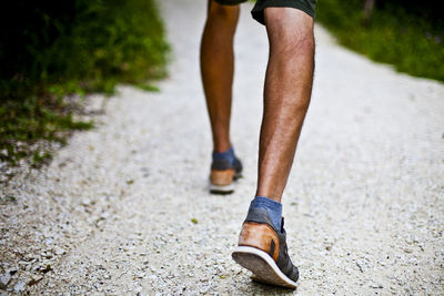 Low section of man running on road