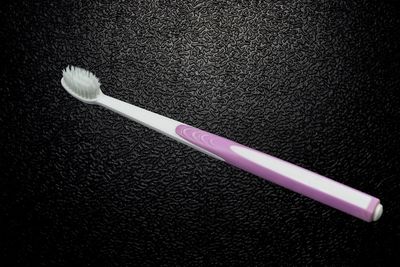 High angle view of fork on rug against black background