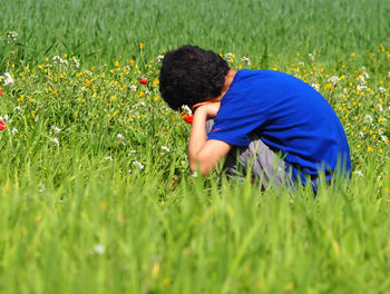 Rear view of kid on field