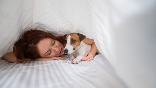 High angle view of dog sleeping on bed