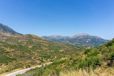 Scenic view of mountains against clear blue sky