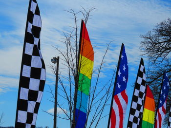 Low angle view of flags against blue sky