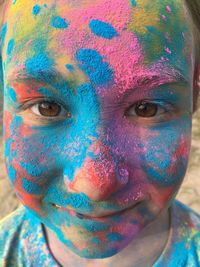 Close-up portrait of a child with face paint