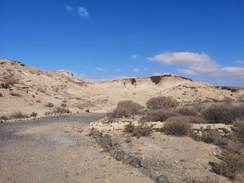 Scenic view of arid landscape against sky