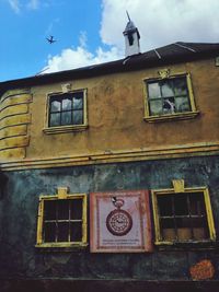 Low angle view of abandoned building against sky