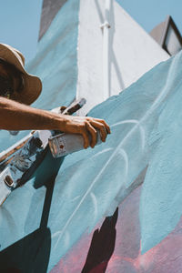 Midsection of man holding umbrella