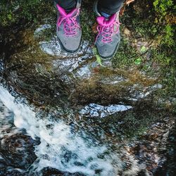 Low section of person standing on rock