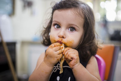 Close-up portrait of a girl eating food