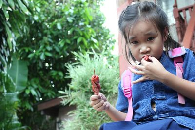 Low angle view of girl eating food