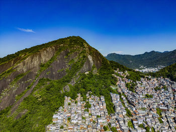 Scenic view of mountains against blue sky