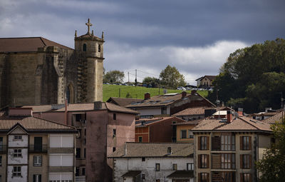 Buildings in city against sky