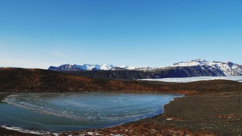 Scenic view of mountains against clear blue sky