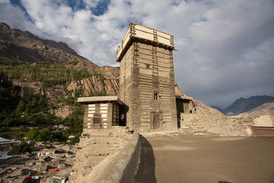 Old building in city against cloudy sky