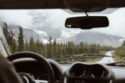 Snowcapped mountain seen through car windshield